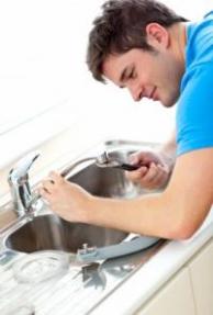 a tech installs a faucet aerator our Kent plumbing contractors fix residential sinks and faucets